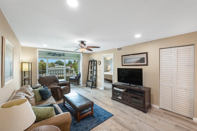 living room featuring light wood-type flooring and ceiling fan