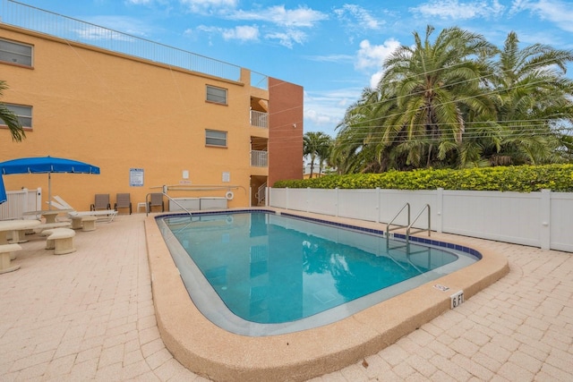 view of swimming pool with a patio