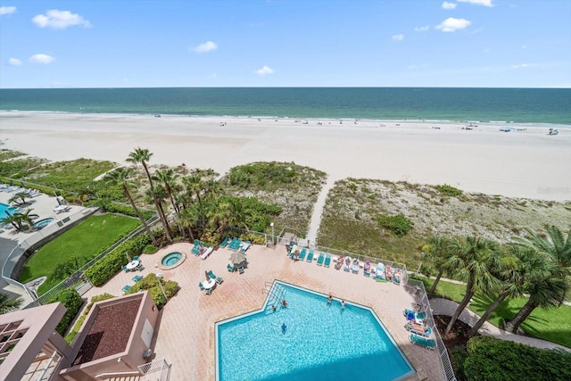 birds eye view of property with a water view and a view of the beach