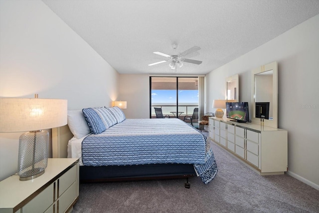 carpeted bedroom with a textured ceiling, ceiling fan, and floor to ceiling windows