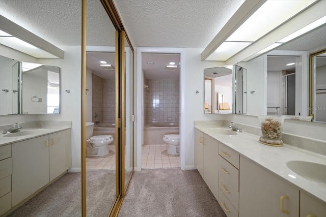 full bathroom featuring a textured ceiling, toilet, tiled shower / bath, and tile patterned flooring