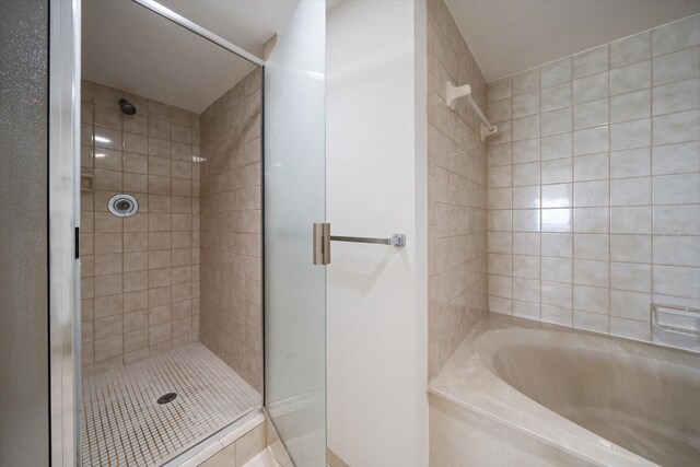 bathroom featuring independent shower and bath and tile patterned floors