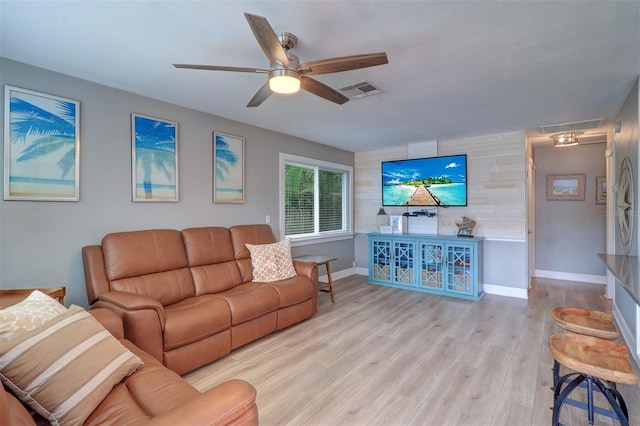 living room with ceiling fan and light hardwood / wood-style flooring