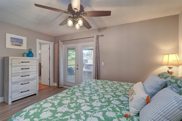 bedroom featuring wood-type flooring, access to outside, french doors, and ceiling fan