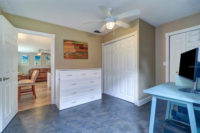 tiled office space featuring ceiling fan