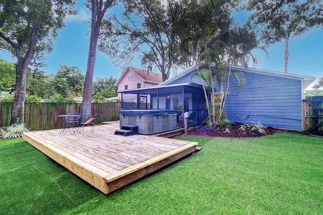 exterior space featuring a hot tub, a yard, and a wooden deck