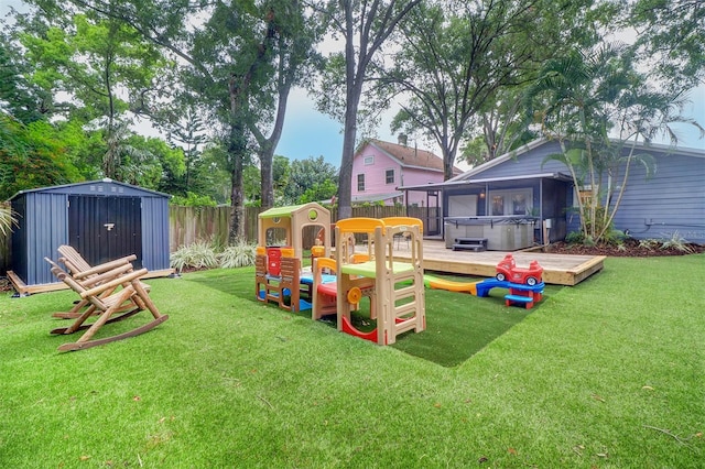 view of yard featuring a storage shed and a wooden deck