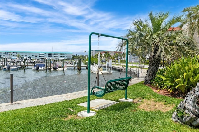 3128 59th St S Unit 214, Gulfport, FL 33707 - surrounding community with a dock, a lawn, uncovered parking, and a water view