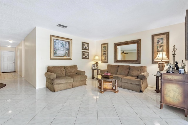 3128 59th St S Unit 214, Gulfport, FL 33707 - living room featuring a textured ceiling, baseboards, light tile patterned floors, and ceiling fan