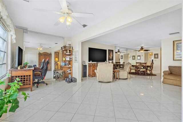 3128 59th St S Unit 214, Gulfport, FL 33707 - living area with a ceiling fan, light tile patterned floors, and stairs