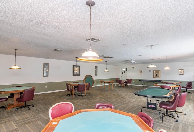 game room with carpet floors and a textured ceiling