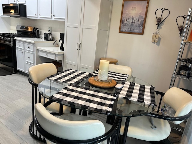 dining space with light hardwood / wood-style flooring