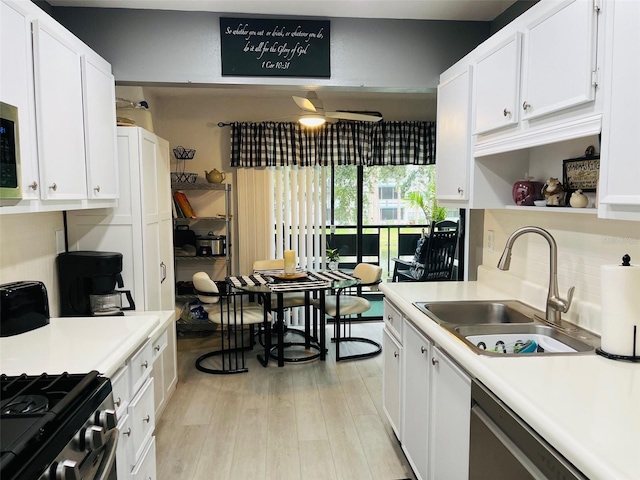 kitchen featuring white cabinets, ceiling fan, light hardwood / wood-style floors, and sink