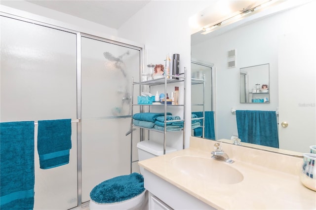 bathroom with vanity, toilet, and an enclosed shower