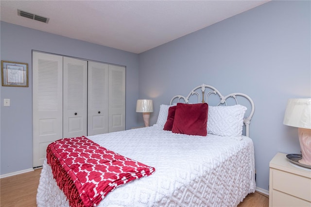 bedroom with a closet and light hardwood / wood-style flooring