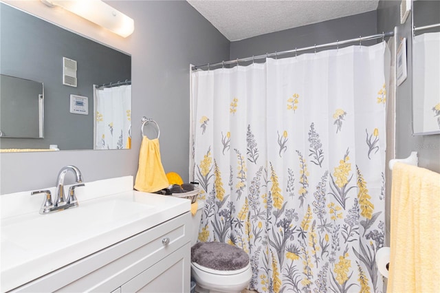 bathroom with vanity, a textured ceiling, toilet, and a shower with shower curtain