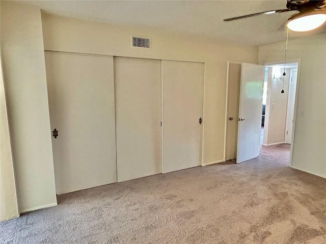 unfurnished bedroom featuring light colored carpet and ceiling fan