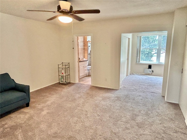 sitting room featuring light carpet and ceiling fan