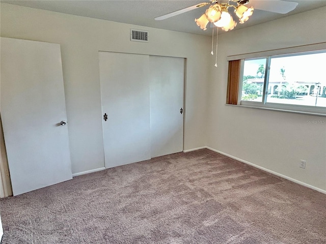 unfurnished bedroom featuring ceiling fan, a closet, and carpet floors