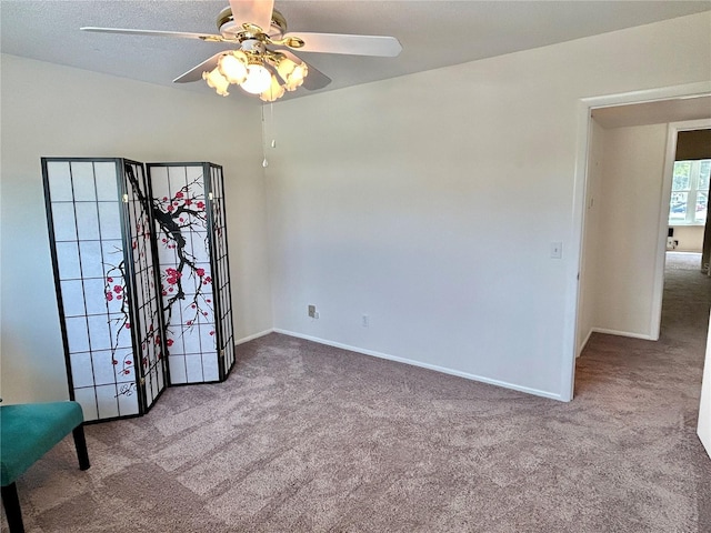 unfurnished room with light colored carpet and ceiling fan