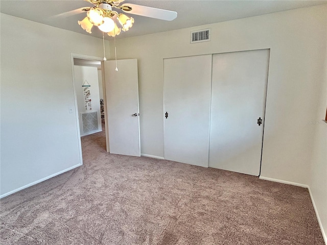 unfurnished bedroom with carpet, ceiling fan, and a closet