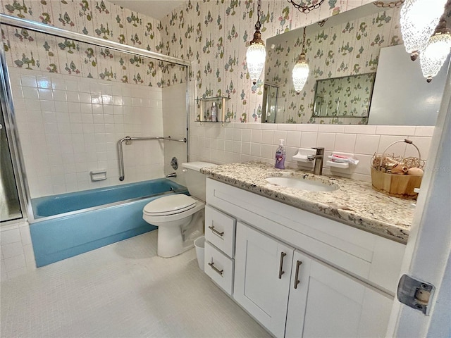 full bathroom featuring vanity, tiled shower / bath, toilet, tile walls, and tasteful backsplash