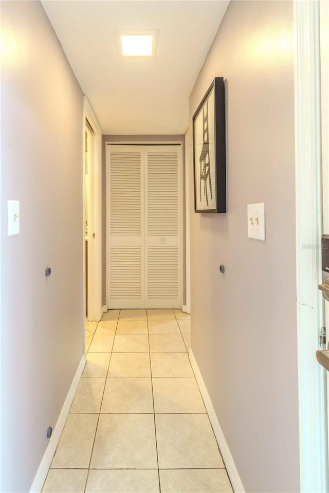 hall with light tile patterned flooring