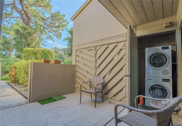 view of patio with stacked washer and clothes dryer