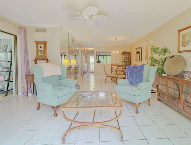 living room featuring ceiling fan, light tile patterned floors, and ornamental molding