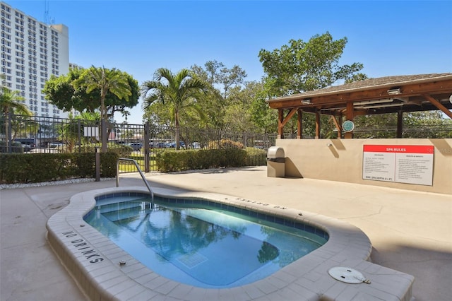 view of pool with a community hot tub and a patio area