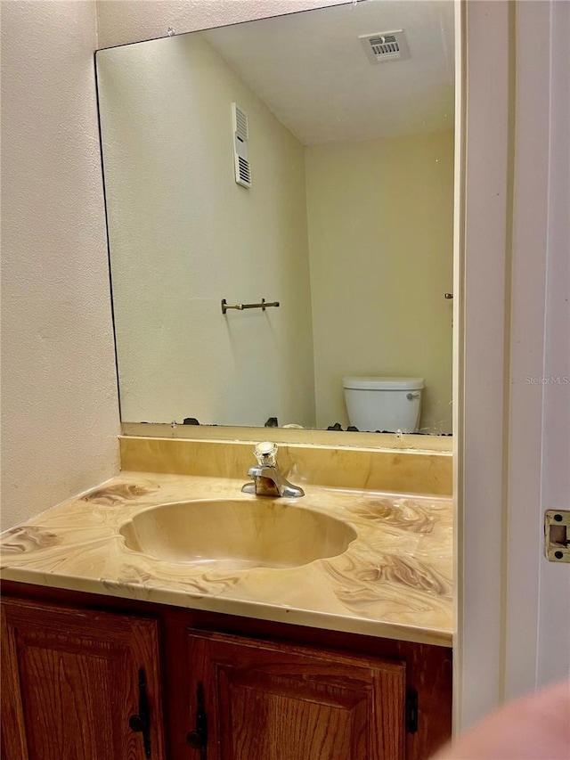 bathroom with vanity and toilet