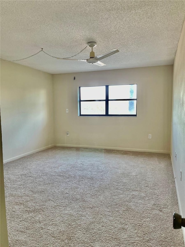 unfurnished room with a textured ceiling, ceiling fan, and carpet flooring