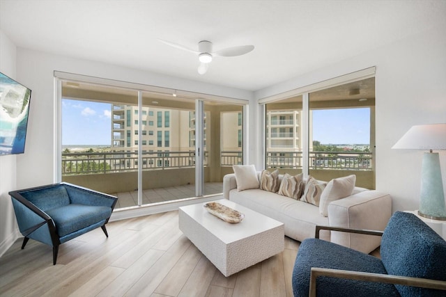 living room featuring ceiling fan and light hardwood / wood-style floors