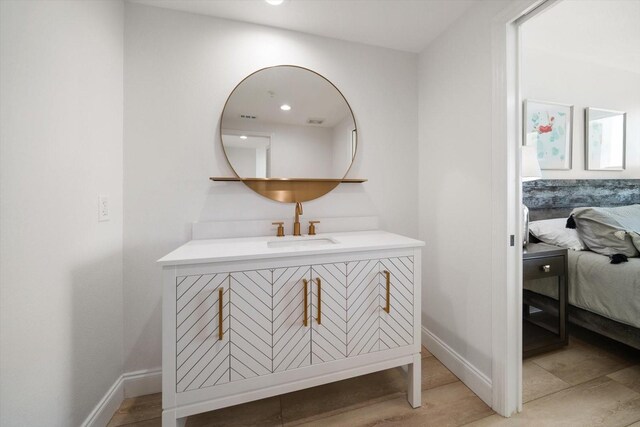 bathroom with hardwood / wood-style floors and vanity