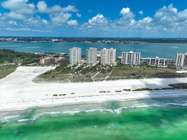 drone / aerial view featuring a beach view and a water view