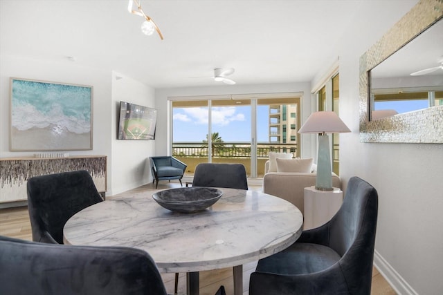 dining space with wood finished floors and baseboards