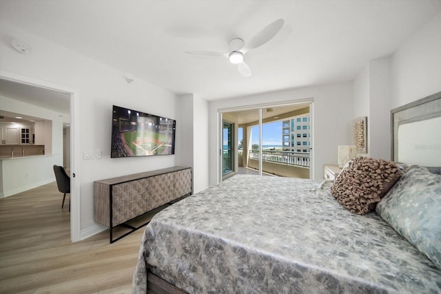 bedroom featuring baseboards, light wood-style floors, a ceiling fan, and access to exterior