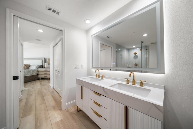 bathroom featuring hardwood / wood-style flooring and double sink vanity