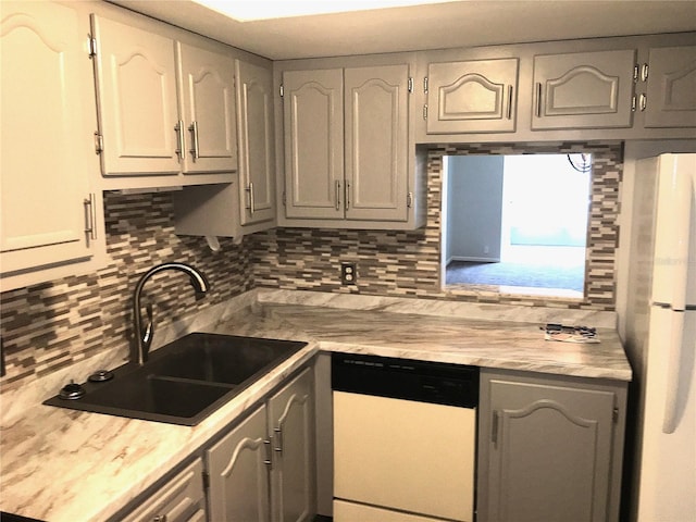 333 Lake Howard Dr NW Unit 204C, Winter Haven, FL 33880 - kitchen featuring white appliances, a sink, decorative backsplash, and light countertops