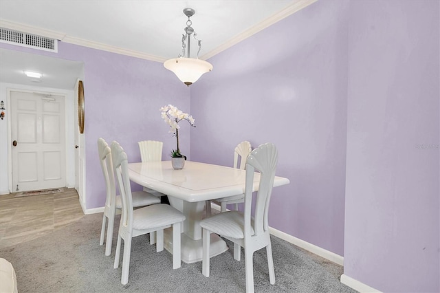 dining space with light carpet and ornamental molding