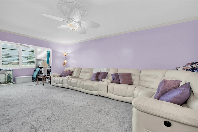 carpeted living room with ceiling fan and ornamental molding