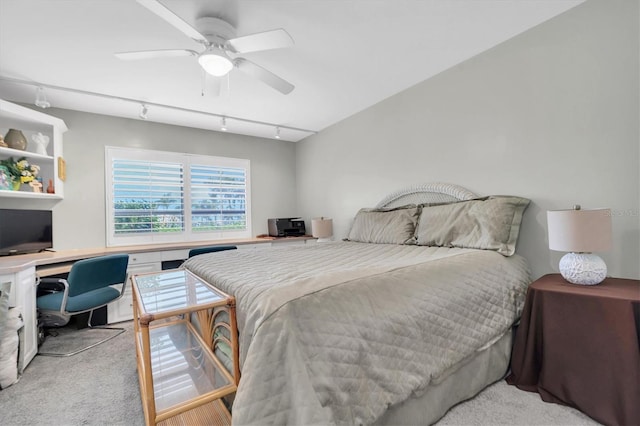 bedroom featuring light carpet, rail lighting, and ceiling fan