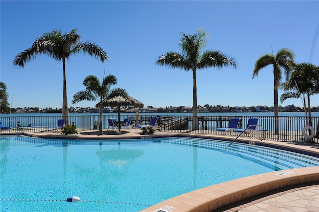 view of swimming pool featuring a water view