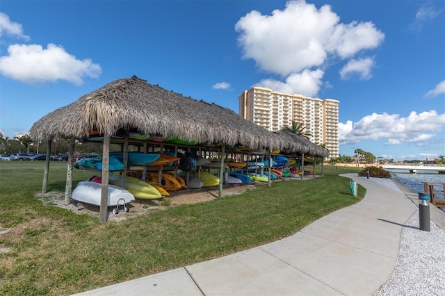view of property's community featuring a water view and a lawn