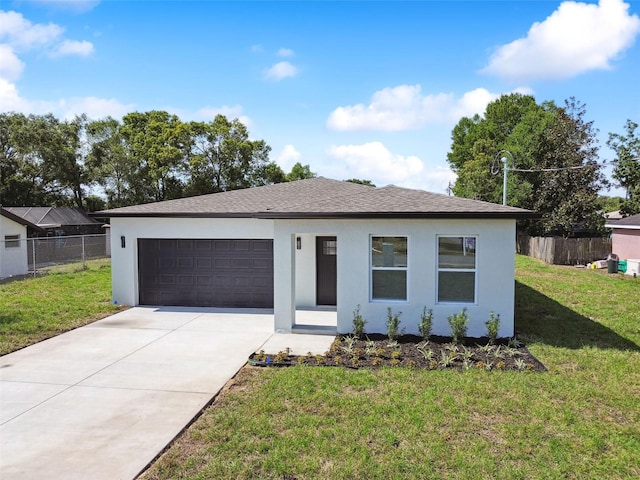 view of front of property with a garage and a front lawn