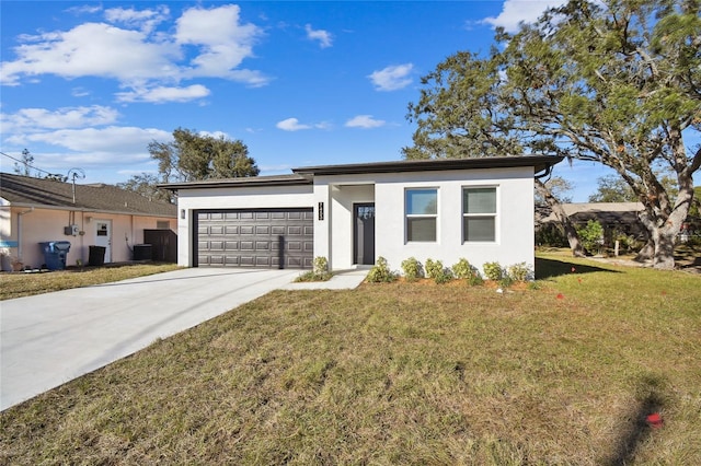 view of front of property featuring a front lawn, a garage, and central air condition unit