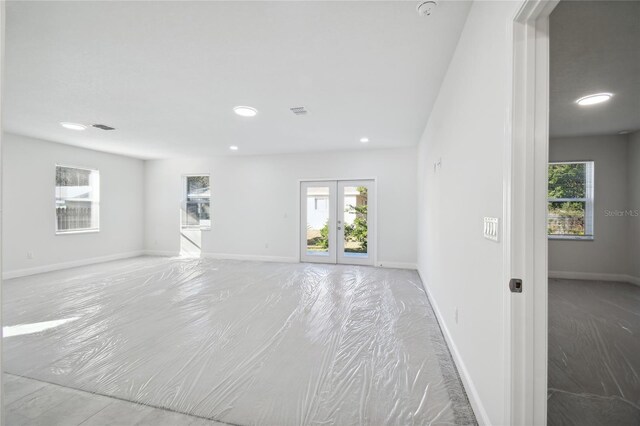 spare room with a healthy amount of sunlight and french doors