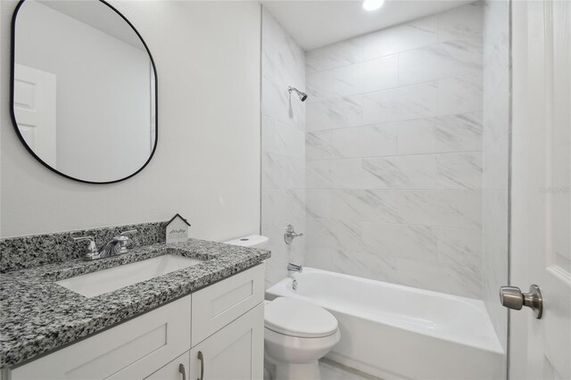 full bathroom featuring tiled shower / bath combo, vanity, and toilet