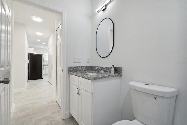 bathroom featuring toilet and vanity