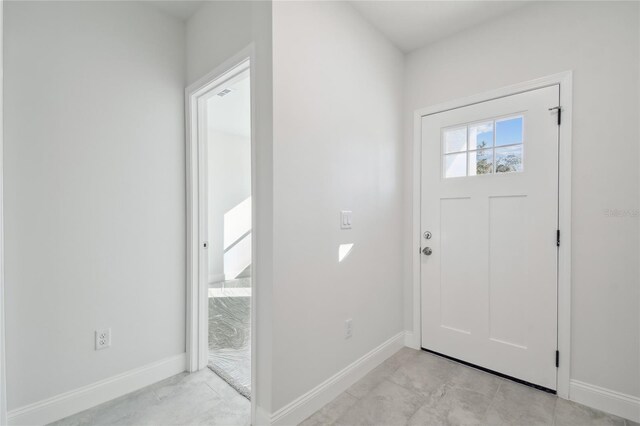 foyer entrance featuring light tile patterned flooring